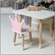 Children's white rectangular table and chair with a pink crown
